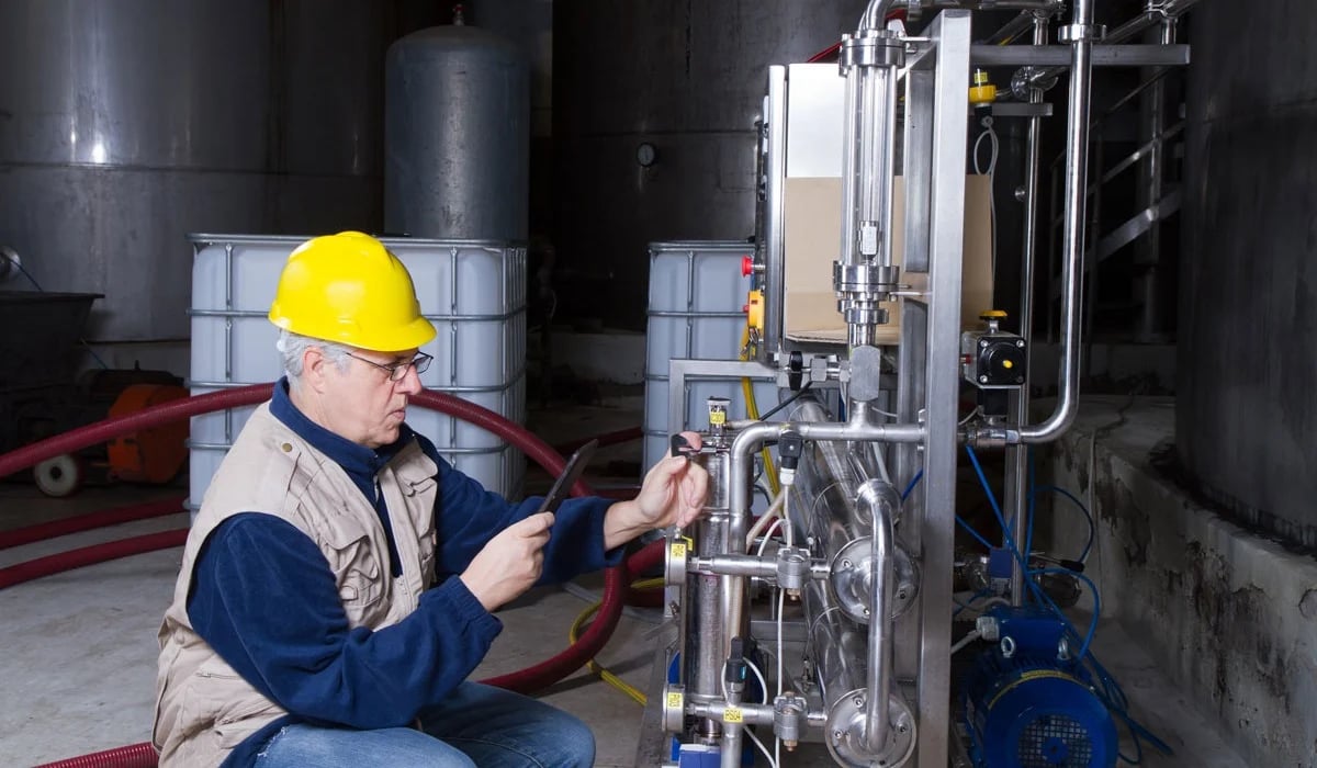 Employee inspecting control valve