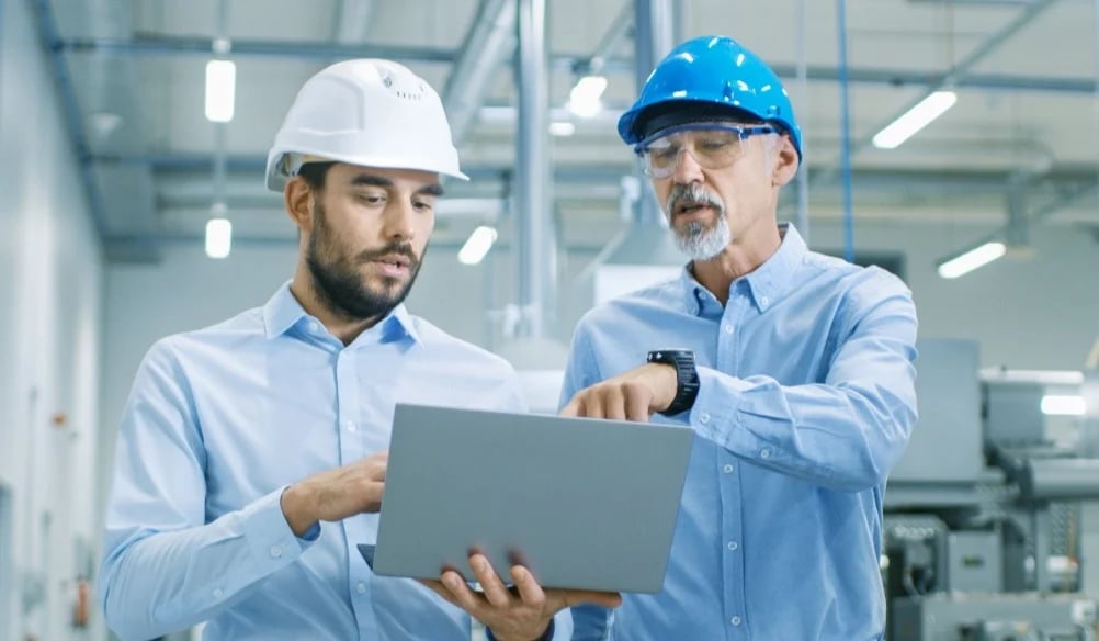 Engineer pointing at screen of laptop