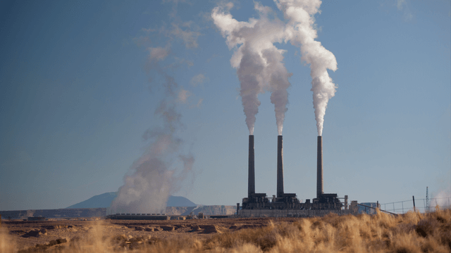 A group of three smoke stacks from a coal fossil fulel plant in the desert (1)