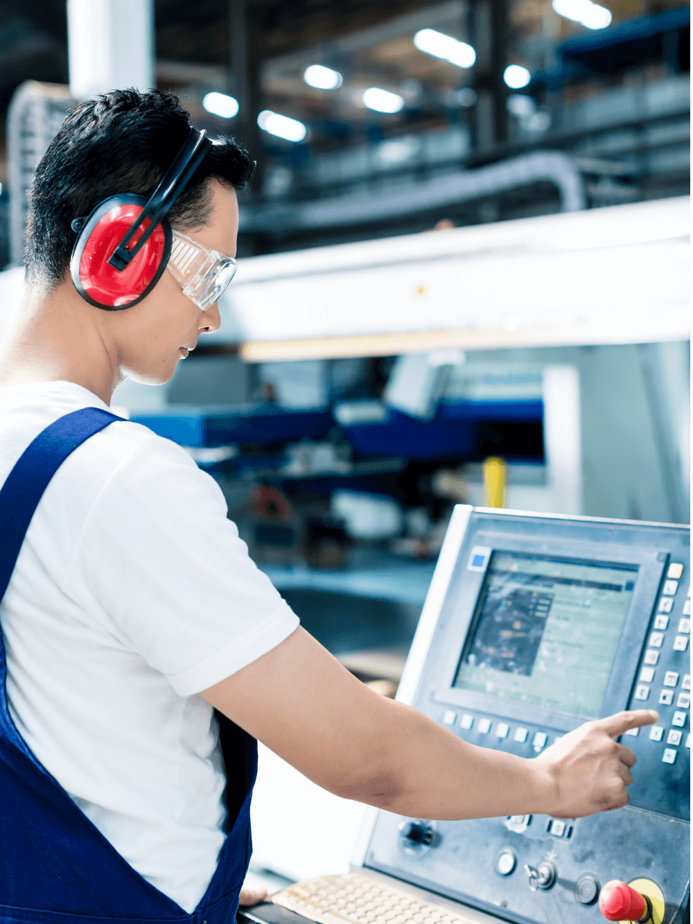 Manufacturing engineering with ear muffs and safety goggles at manufacturing machine