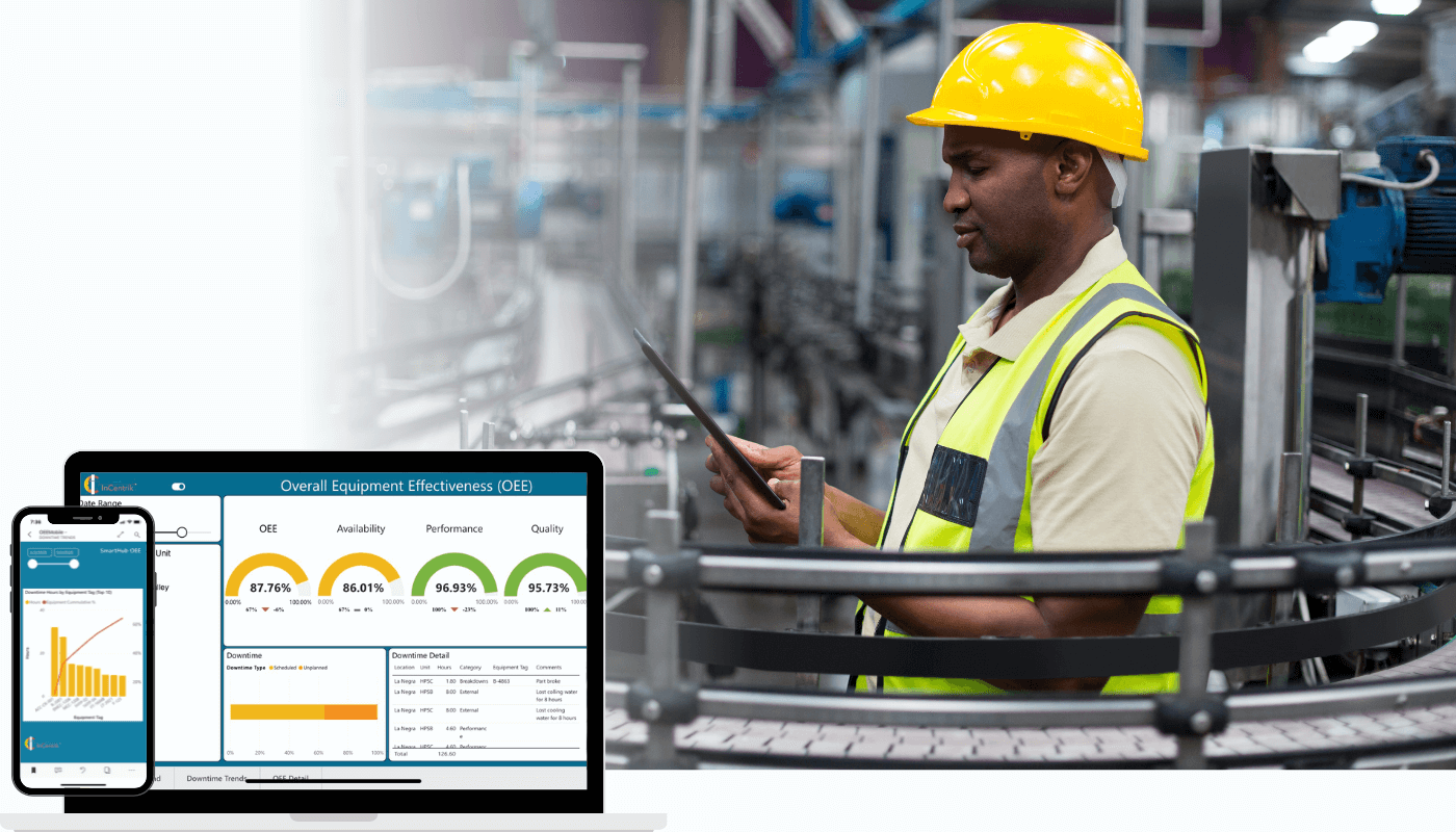 An industrial worker using technology with a computer in the foreground