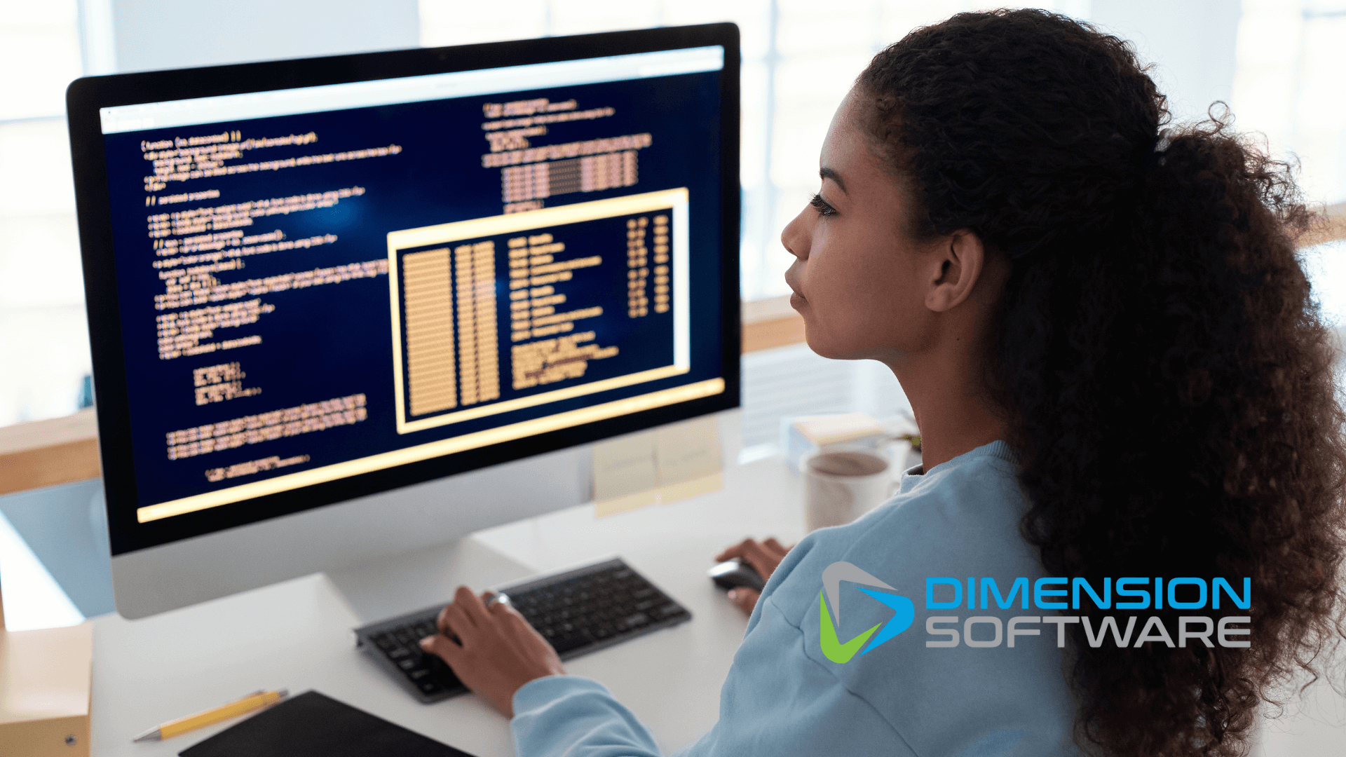 A woman who is using a computer to look at industrial automation data. (1)